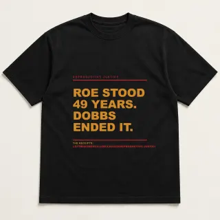 Front of a black tee reading "Roe stood 49 years. Dobbs ended it." with the Reproductive Justice page address printed under it